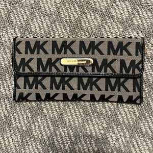 Authentic Michael Kors black/tan initial wallet.